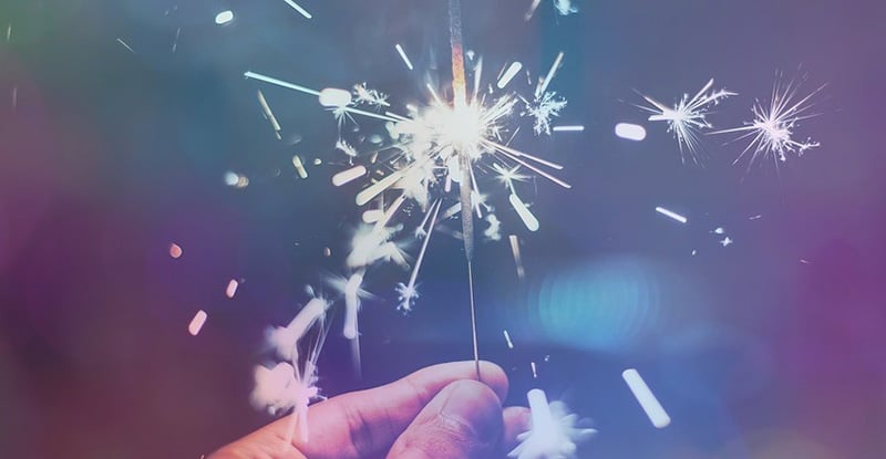 A photo of a person holding a sparkler creating a whimsical look.