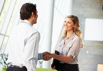 Other Opportunities  A woman and a man are shaking hands in an office setting.